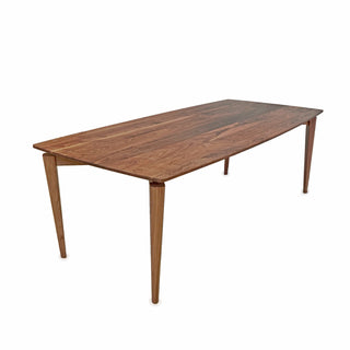 Wooden dining table with tapered legs.