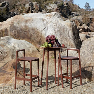 Outdoor dining set with food on a rock.
