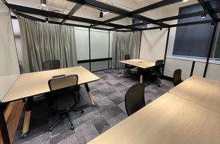 Office meeting room with tables and chairs.