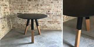 Nookieround round black table with wood legs.