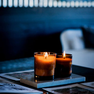 Lit candles on a marble tray