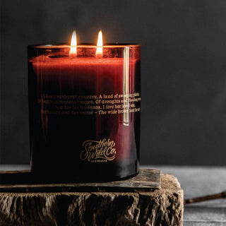 Southern Wild Co. candle lit on wood