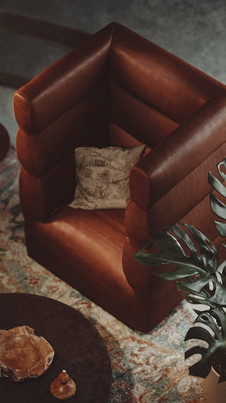 Brown leather armchair with decorative pillow