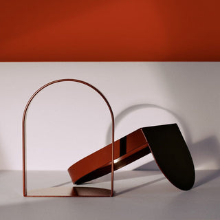Abstract metal sculpture on white and orange background