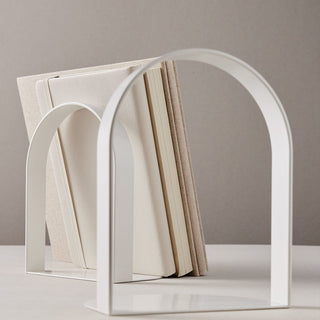 White arch bookend holding books - Passage8