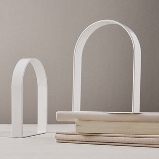 White arch bookends on books
