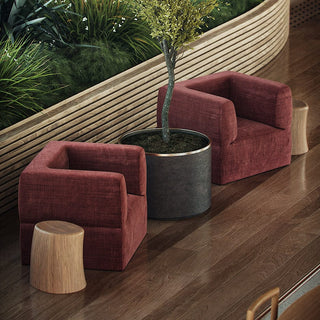 Red armchairs with plant and wooden stools