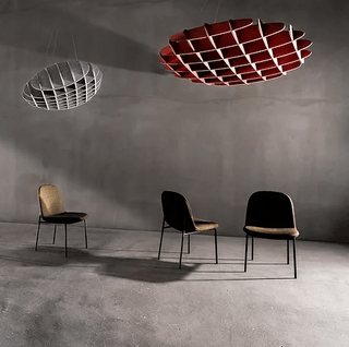 Modern interior with geometric lighting and chairs.