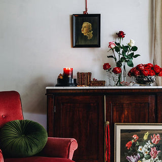Red velvet chair with roses and antique decor