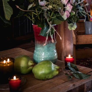 Still life with pears, candles, and vase