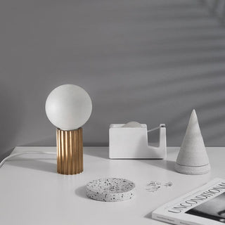 Table lamp with gold base and white globe