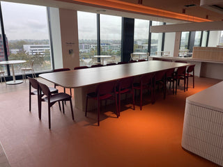 Titanic table in modern office with chairs.