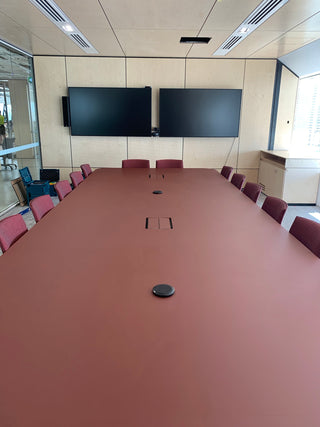 Conference room table with two large screens