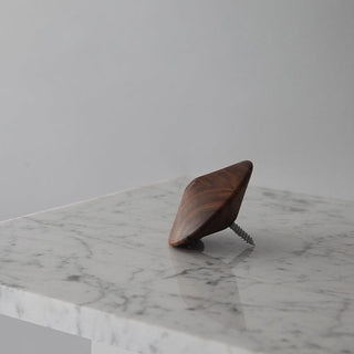 Wooden wall hook on marble surface