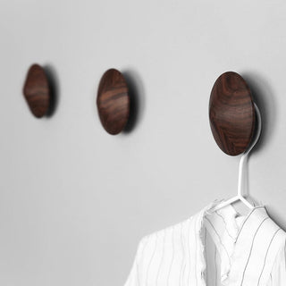 Decorative wooden wall hooks holding clothing