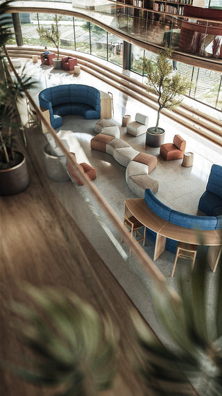 Modern open-plan interior with seating areas and plants.