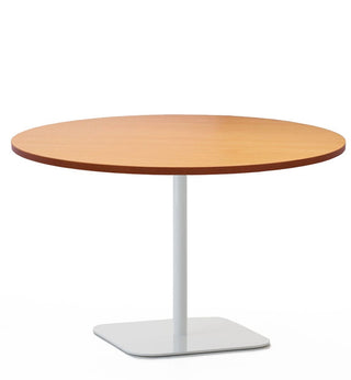 Round table with light wood top and white pedestal base.
