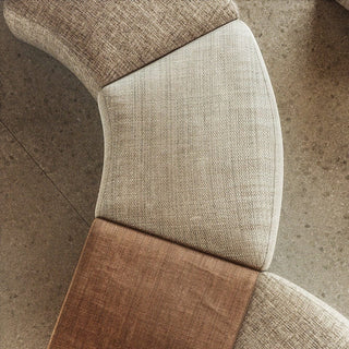 Curved sectional sofa with neutral fabric.
