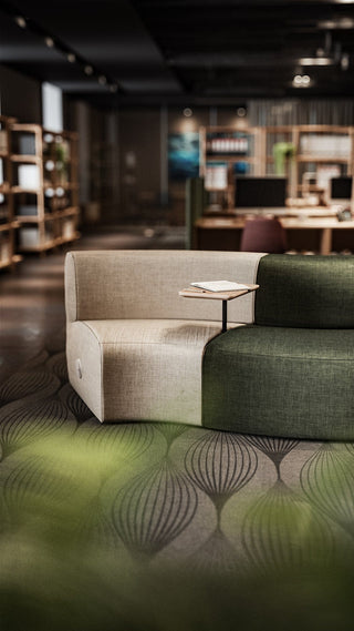 Beige and green sofa in a modern office space.
